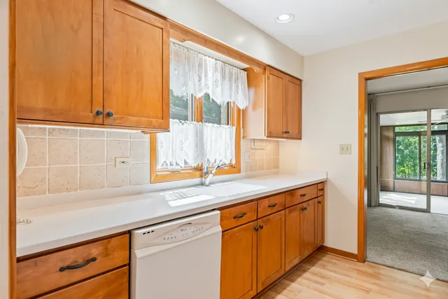 a kitchen with stainless steel appliances a sink and cabinets