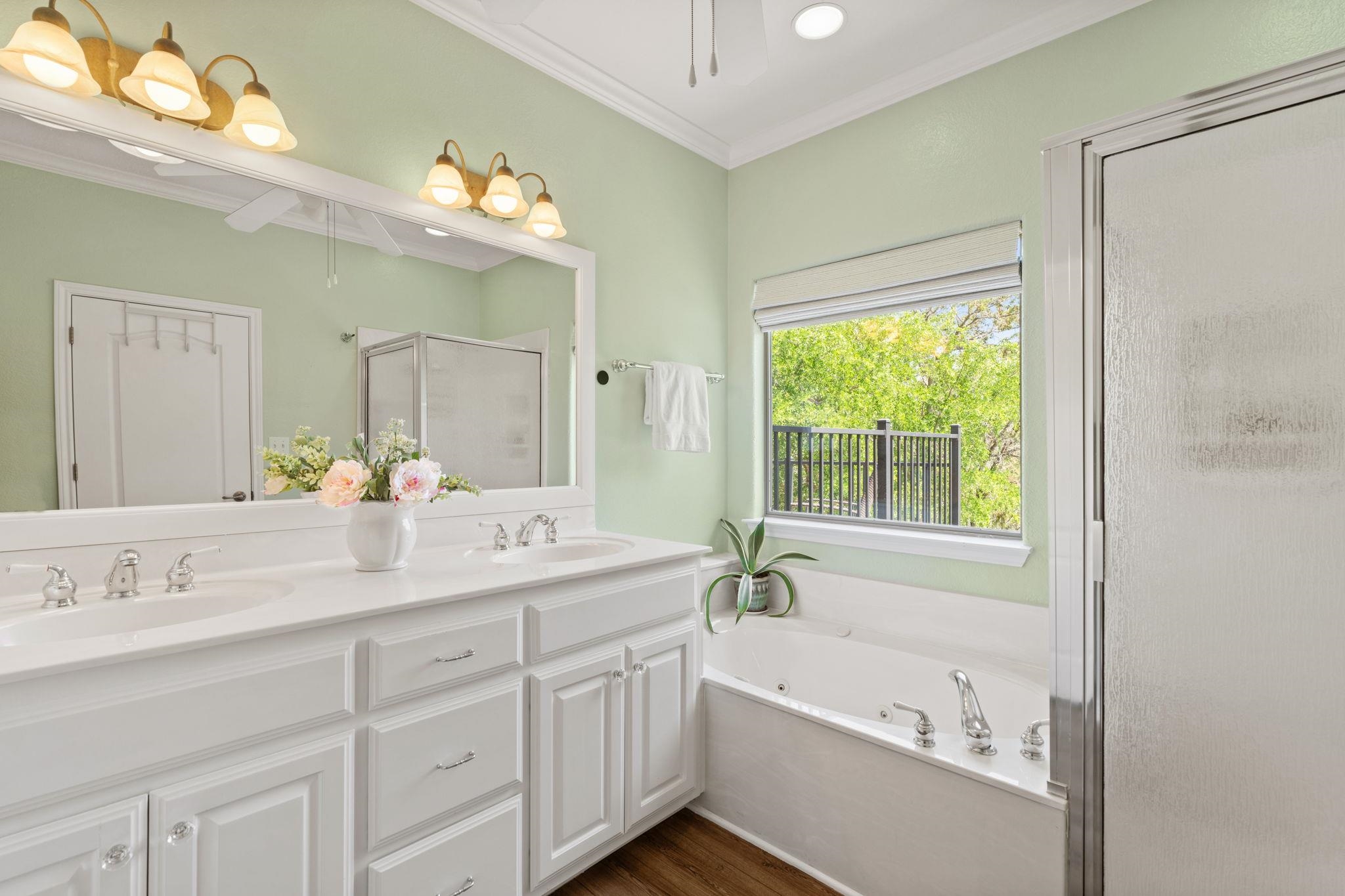 2409 Mormon Mill Road Marble Falls, TX 78654 - Photo 17 of 30 a bathroom with a tub a sink and mirror