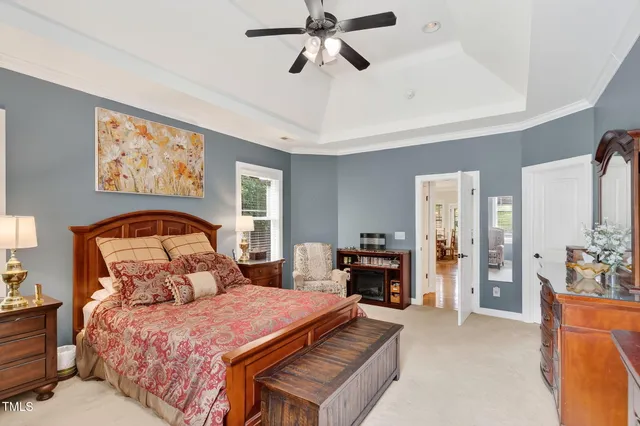 a bedroom with a bed and a chandelier