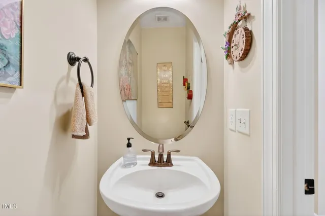 a bathroom with a sink and mirror