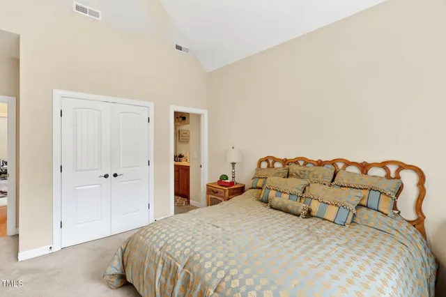 a bedroom with a bed and a night stand