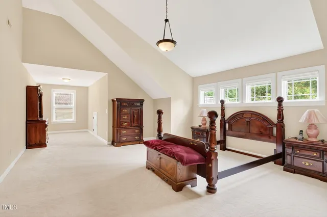 a spacious bedroom with two beds and a chandelier