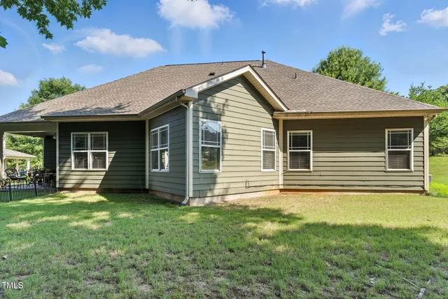 a view of a yard with yellow house