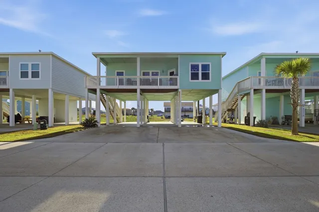 a view of a house with a swimming pool and sitting area