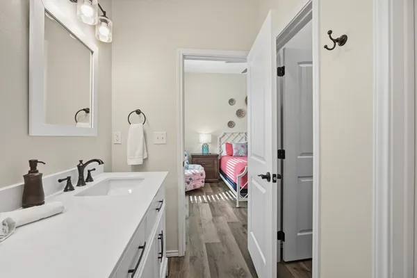 a en suite bathroom with a sink a mirror a vanity and shower