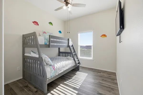a bedroom with furniture and wooden floor