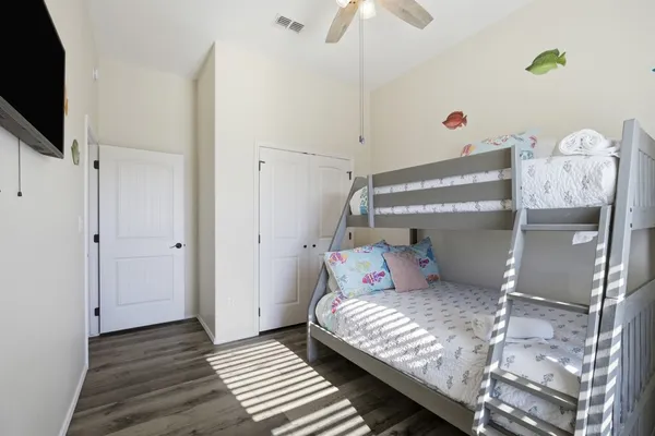 a bedroom with a bed and flat screen tv