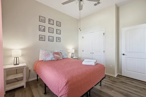 a bedroom with a bed and a chandelier