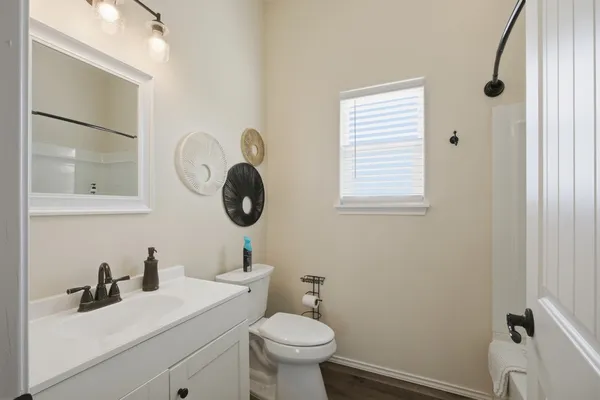 a bathroom with a toilet a sink and mirror