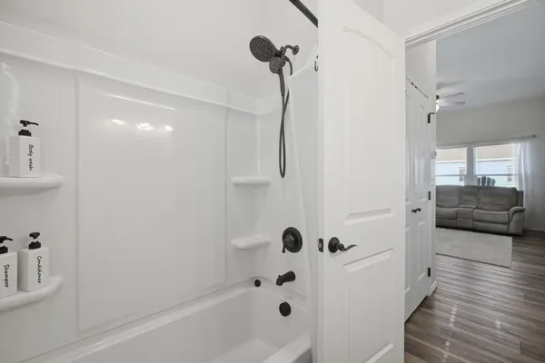 a bathroom with a bathtub and a shower