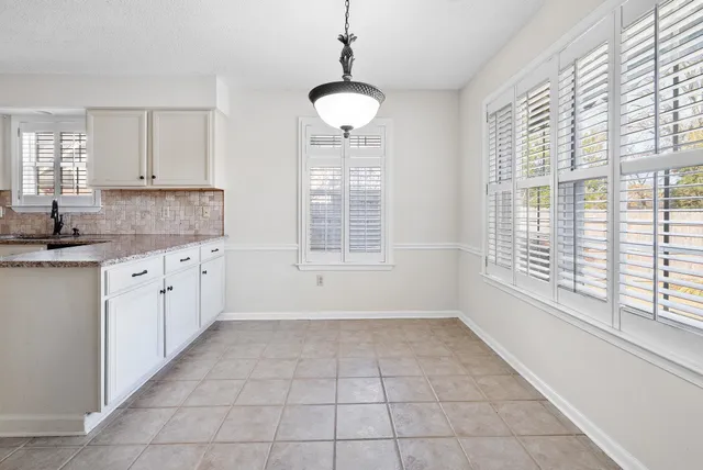 a kitchen with a stove a sink and cabinets