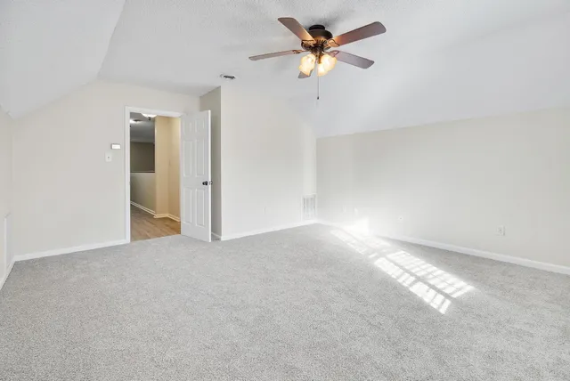 an empty room with a empty space and a ceiling fan