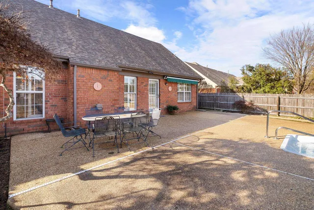 a view of a patio with table and chairs and potted plants