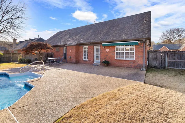 a backyard of a house with yard and outdoor seating