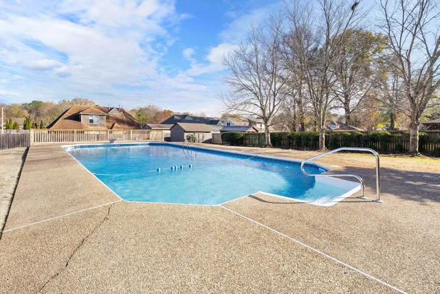 a view of a swimming pool with an outdoor seating