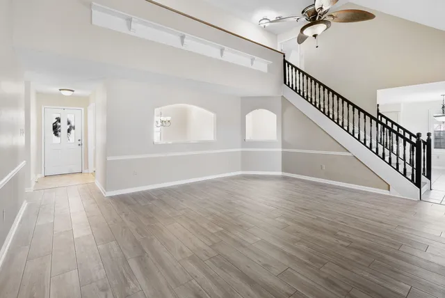 a view of an empty room with wooden floor