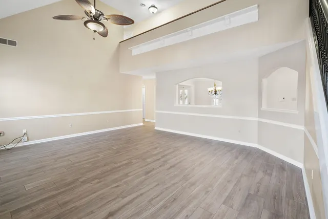 wooden floor in an empty room with a window