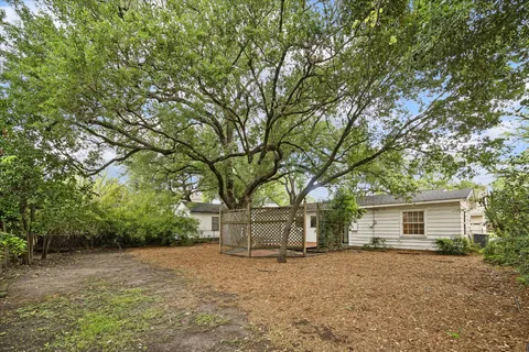 a view of a house with a tree beside of it
