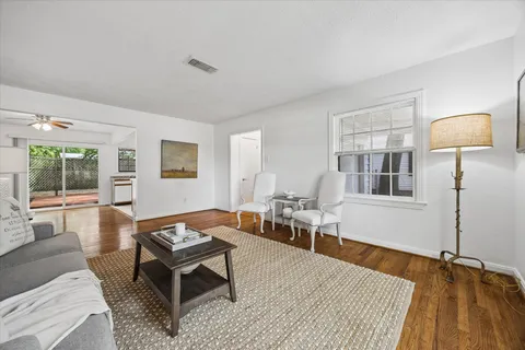 a living room with furniture a rug and a window