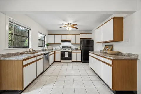a kitchen with stainless steel appliances granite countertop a stove a sink dishwasher and a refrigerator