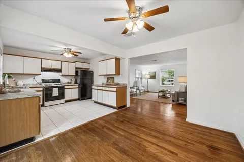 a kitchen with a refrigerator and a stove top oven