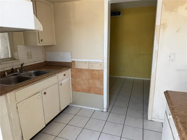 a kitchen with a sink and cabinets