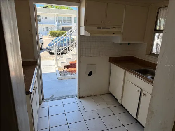 a kitchen with a refrigerator and cabinets