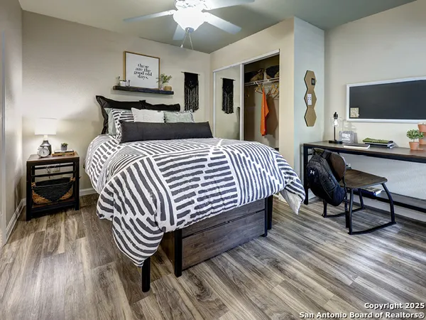a bedroom with a bed and a chandelier