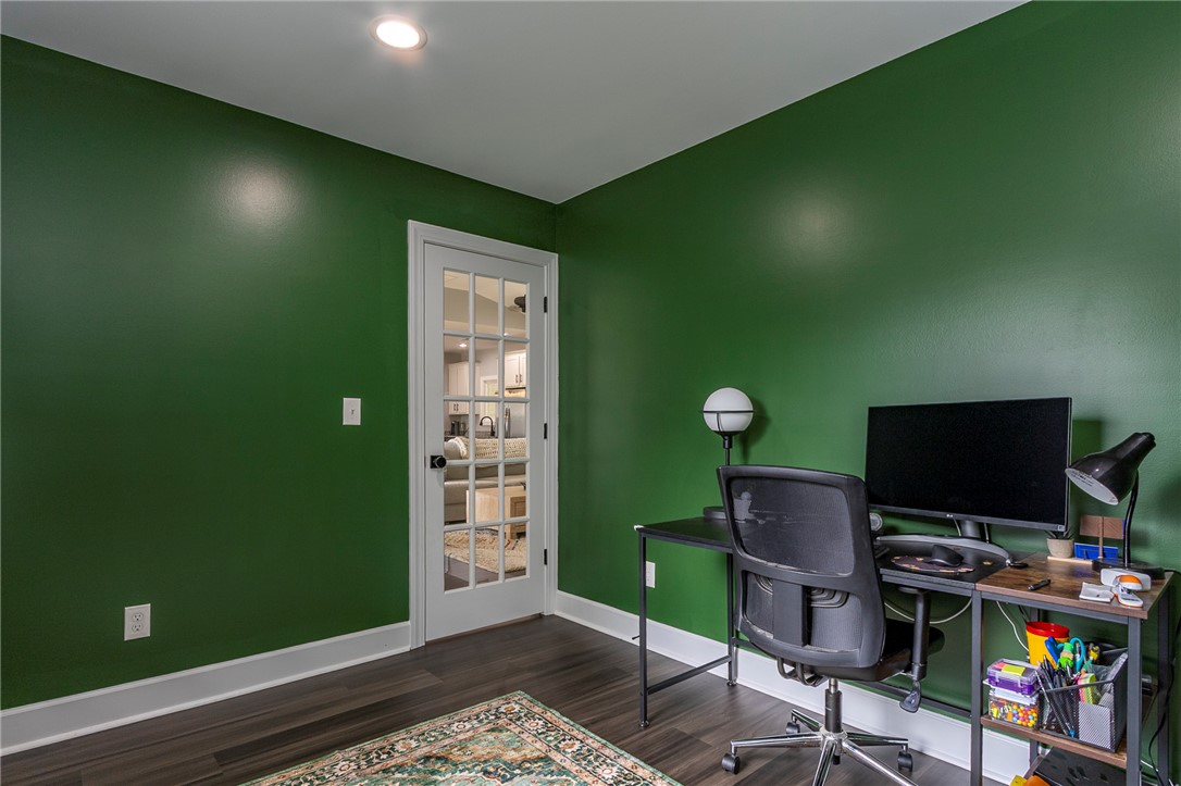 3080 McGee Road Iva, SC 29655 - Photo 18 of 49 A dedicated home office space features rich green walls and durable wood-look flooring.