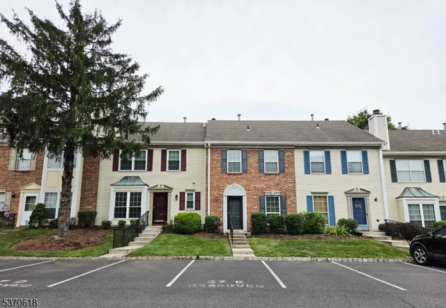 a front view of a residential apartment building with a yard