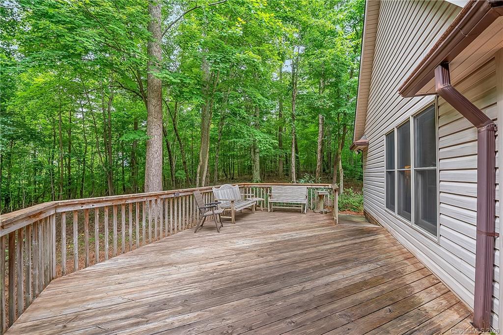 215 Beechtree Circle Rutherfordton, NC 28139 - Photo 35 of 42 a view of house with deck outdoor seating and trees in the background