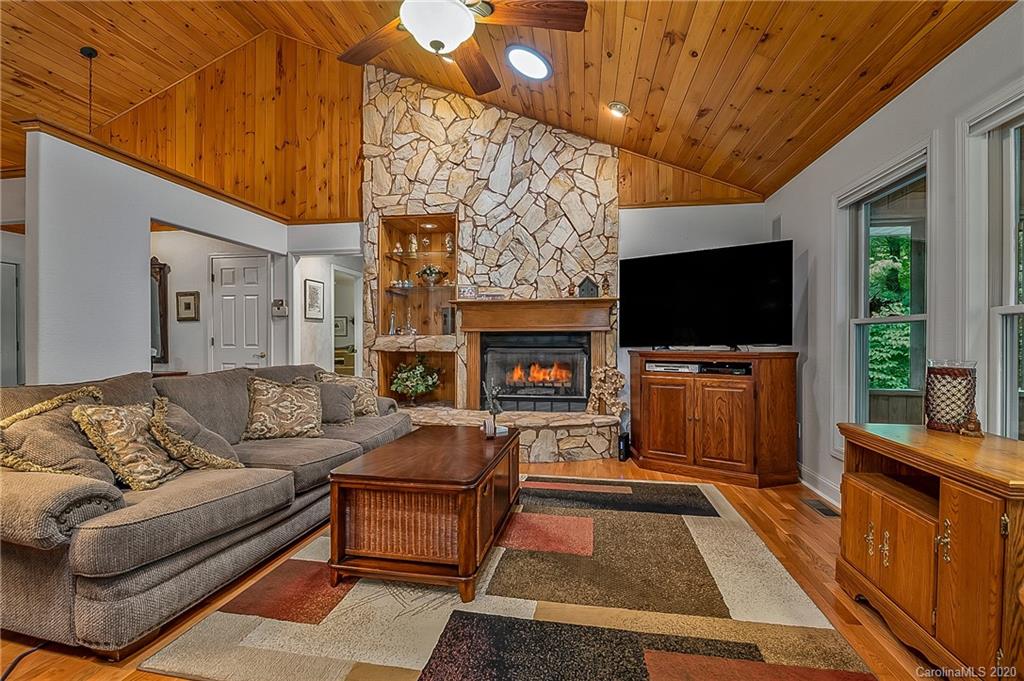 215 Beechtree Circle Rutherfordton, NC 28139 - Photo 9 of 42 a living room with furniture a flat screen tv and a fireplace