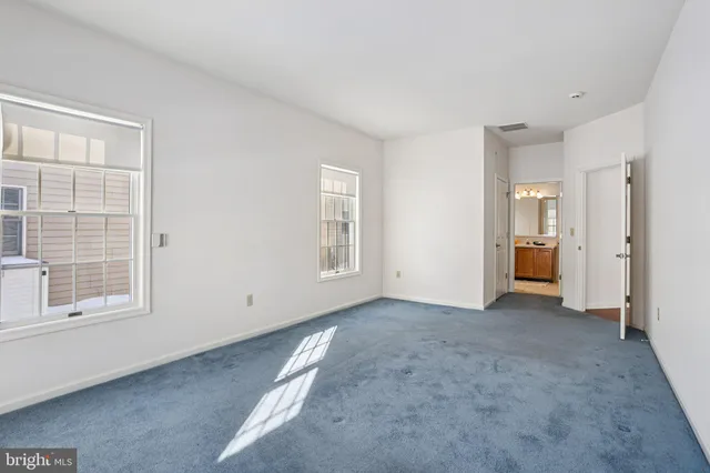 a large bed sitting in a bedroom next to a window