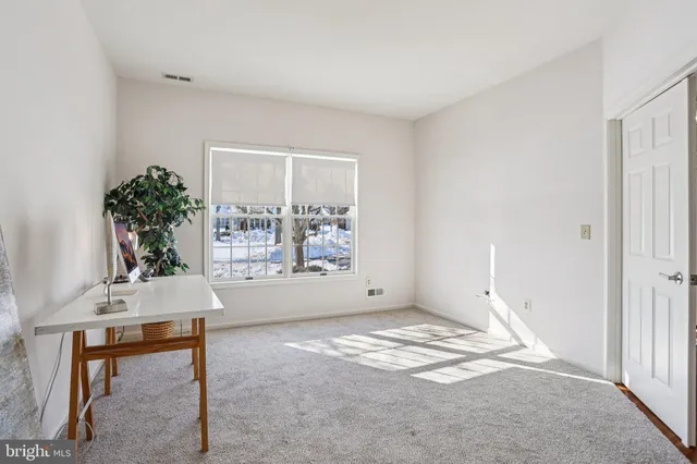 a view of a room with windows and ceiling fan