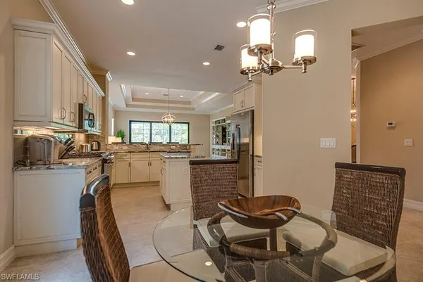 a view of a dining room with furniture and chandelier