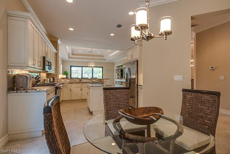 6564 Roma Way Naples, FL 34113 - Photo 11 of 22 a view of a dining room with furniture and chandelier