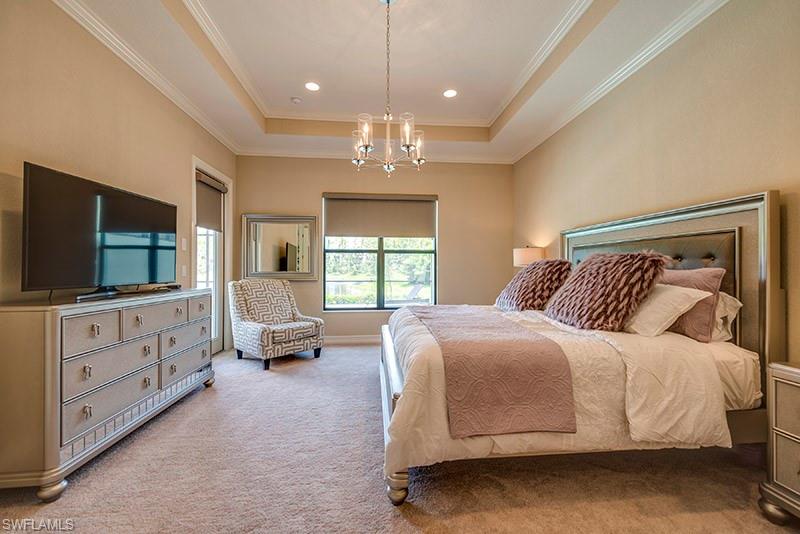 6564 Roma Way Naples, FL 34113 - Photo 12 of 22 a spacious bedroom with a bed and a flat screen tv