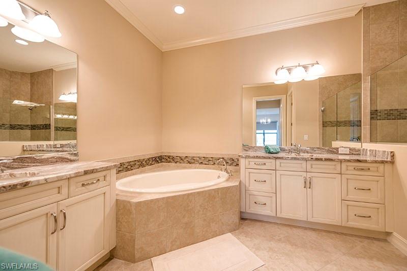 6564 Roma Way Naples, FL 34113 - Photo 13 of 22 a bathroom with a granite countertop sink and a mirror