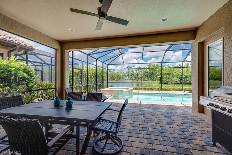 6564 Roma Way Naples, FL 34113 - Photo 19 of 22 a living room with fireplace furniture and a floor to ceiling window