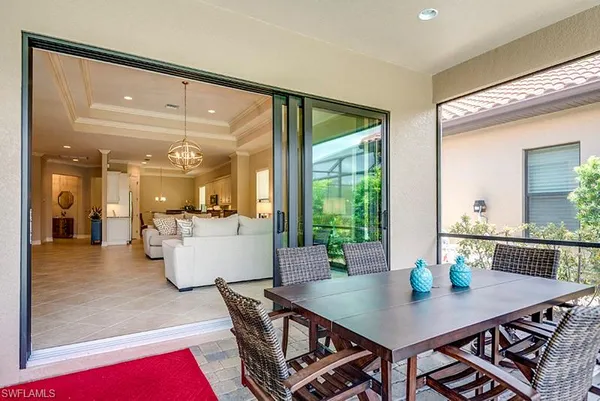 a view of a dining room with furniture and a large window