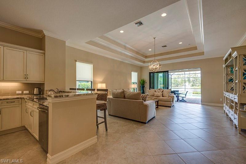 6564 Roma Way Naples, FL 34113 - Photo 2 of 22 a living room with furniture and a open kitchen view
