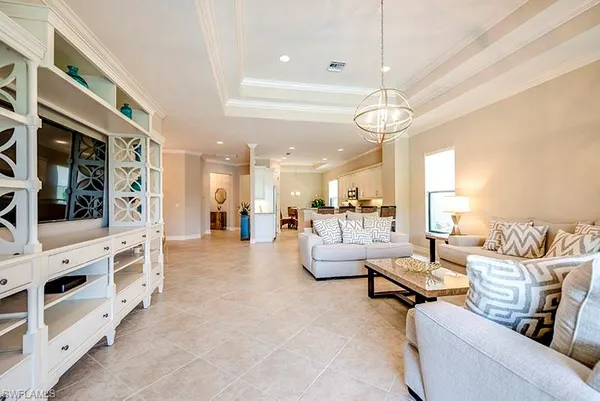 a living room with furniture and a chandelier