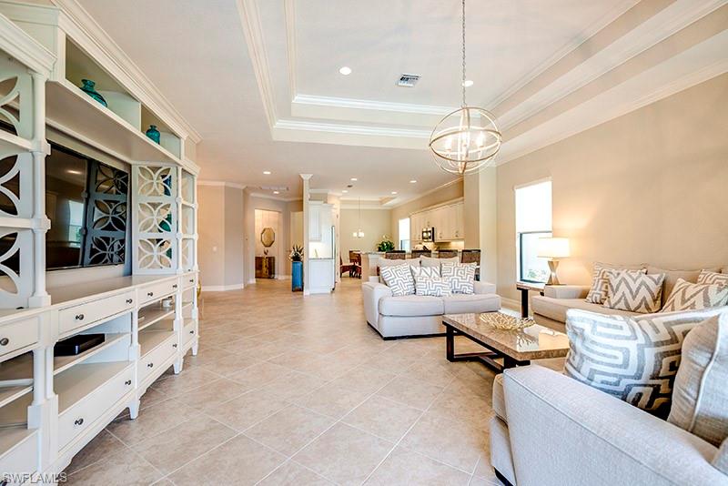 6564 Roma Way Naples, FL 34113 - Photo 5 of 22 a living room with furniture and a chandelier