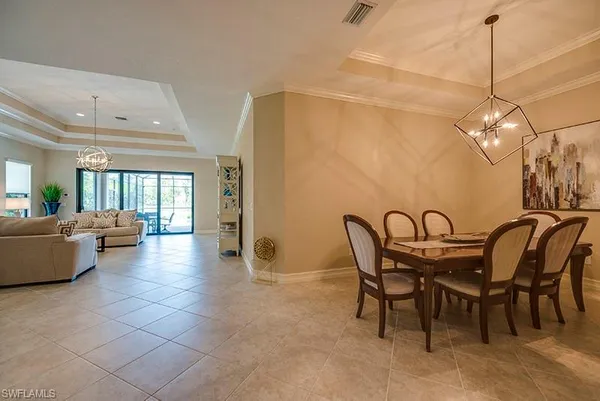 a dining room with furniture and window