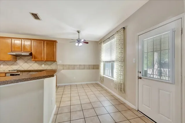 a spacious bathroom with a granite countertop sink a mirror and a bathtub