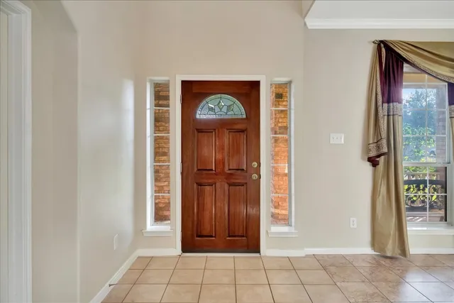 a view of an entryway with wooden floor