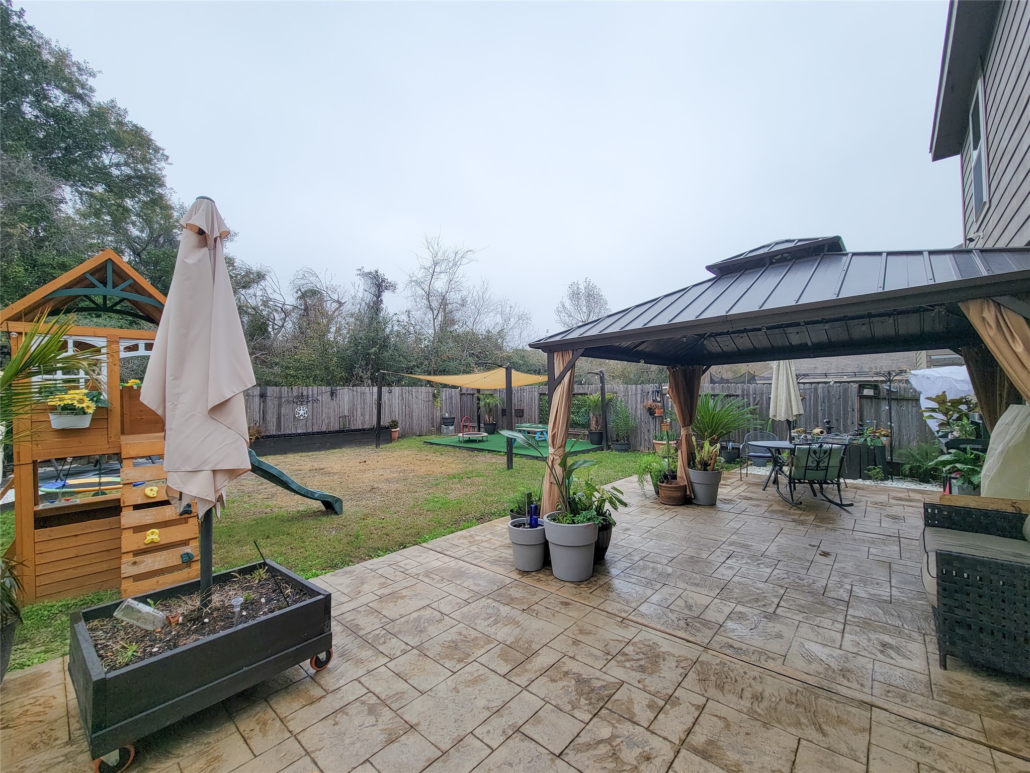 a view of a house with backyard and sitting area