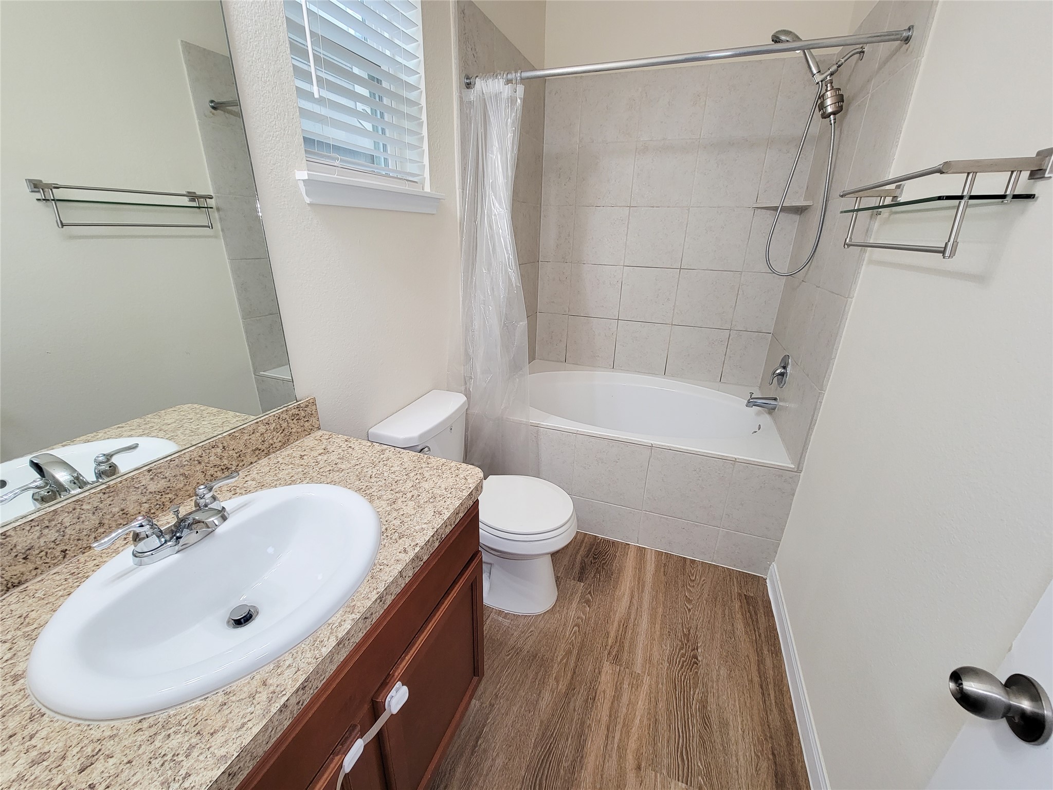 13111 Italian Cypress Trail Houston, TX 77044 - Photo 11 of 17 a bathroom with a granite countertop sink toilet and shower