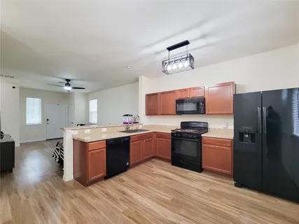a kitchen with a stove sink and refrigerator