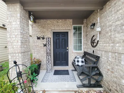 a front view of a house with potted plants